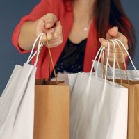 Woman with shopping bags on a blue background